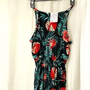 BRAND NEW LOVE AT FIRST SIGHT. BLACK SHORTS ROMPER WITH PALM DESIGN.